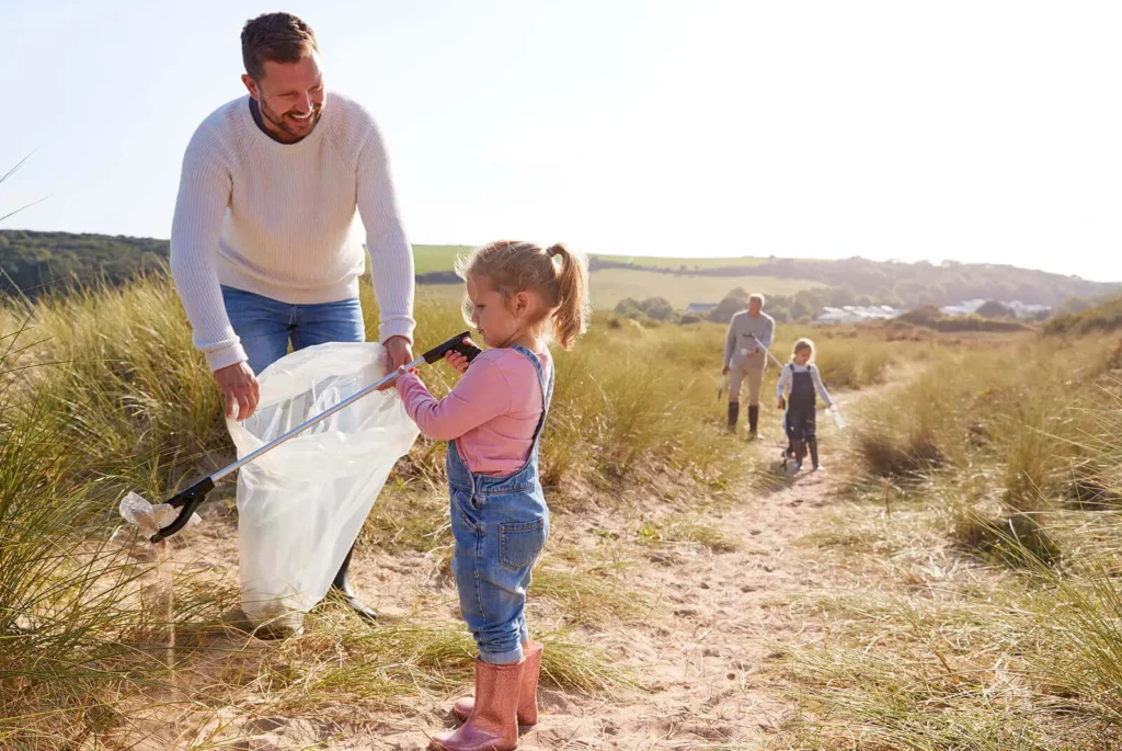 family litter picking beach dunes