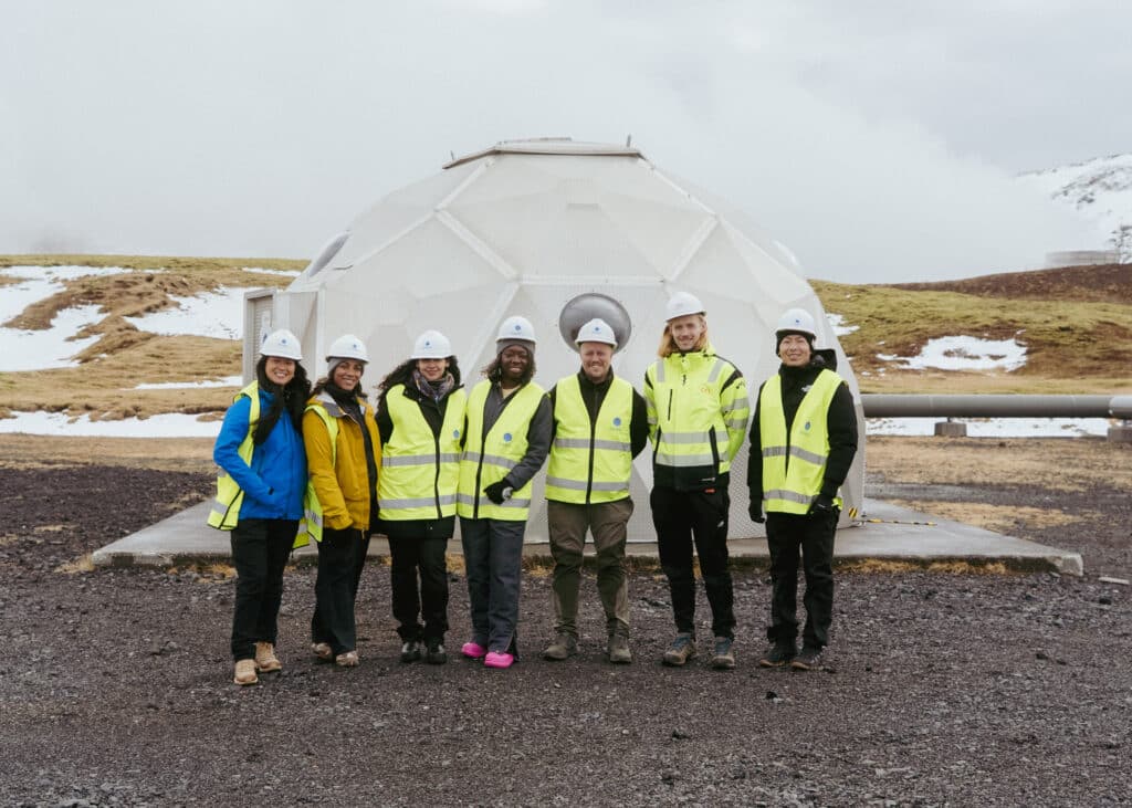 From Iceland to Impact: Chelsea's Inspiring Sustainability Journey at Citi for Accessible Housing & Economic Progress 2 Professionals in protective vests and helmets in front of a geothermal borehole and injection well
